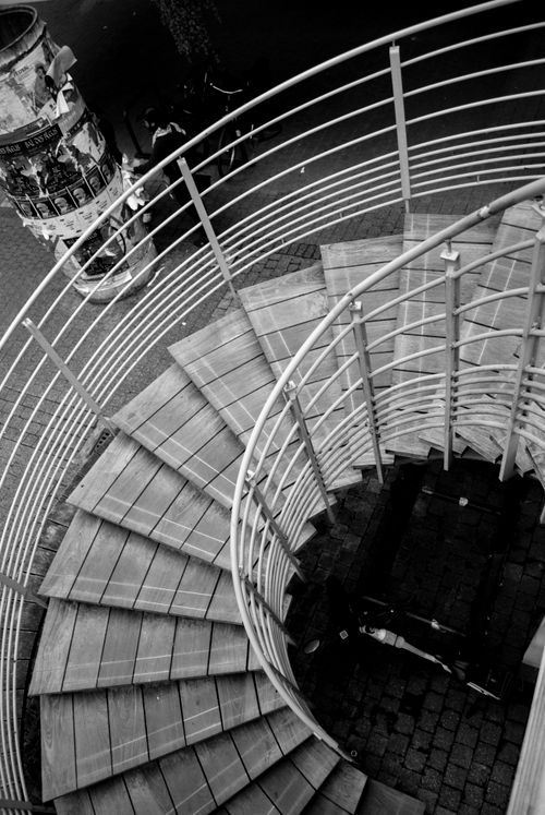 Free A black and white aerial view of a spiral staircase in an urban setting. Stock Photo