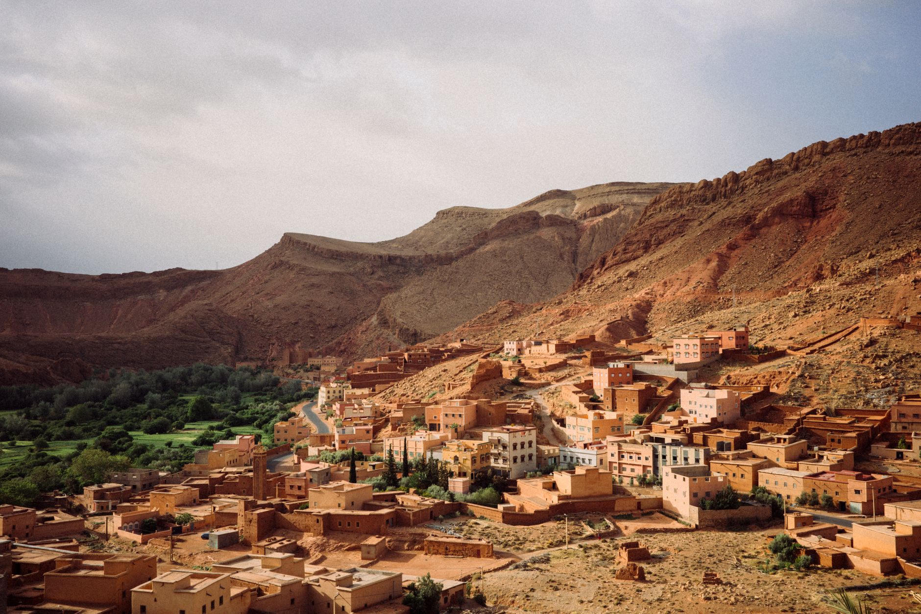 Scenic aerial view of a traditional village in Morocco surrounded by desert mountains.