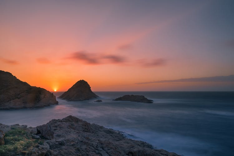 Body Of Water During Sunset