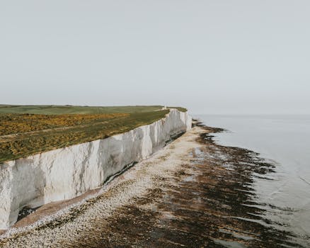 A stunning aerial view of the iconic white cliffs of Dover against a tranquil sea.