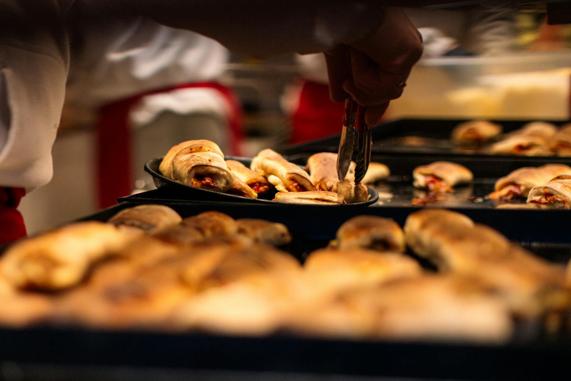 Freshly baked pizza rolls being served at a market in Düsseldorf, Germany.