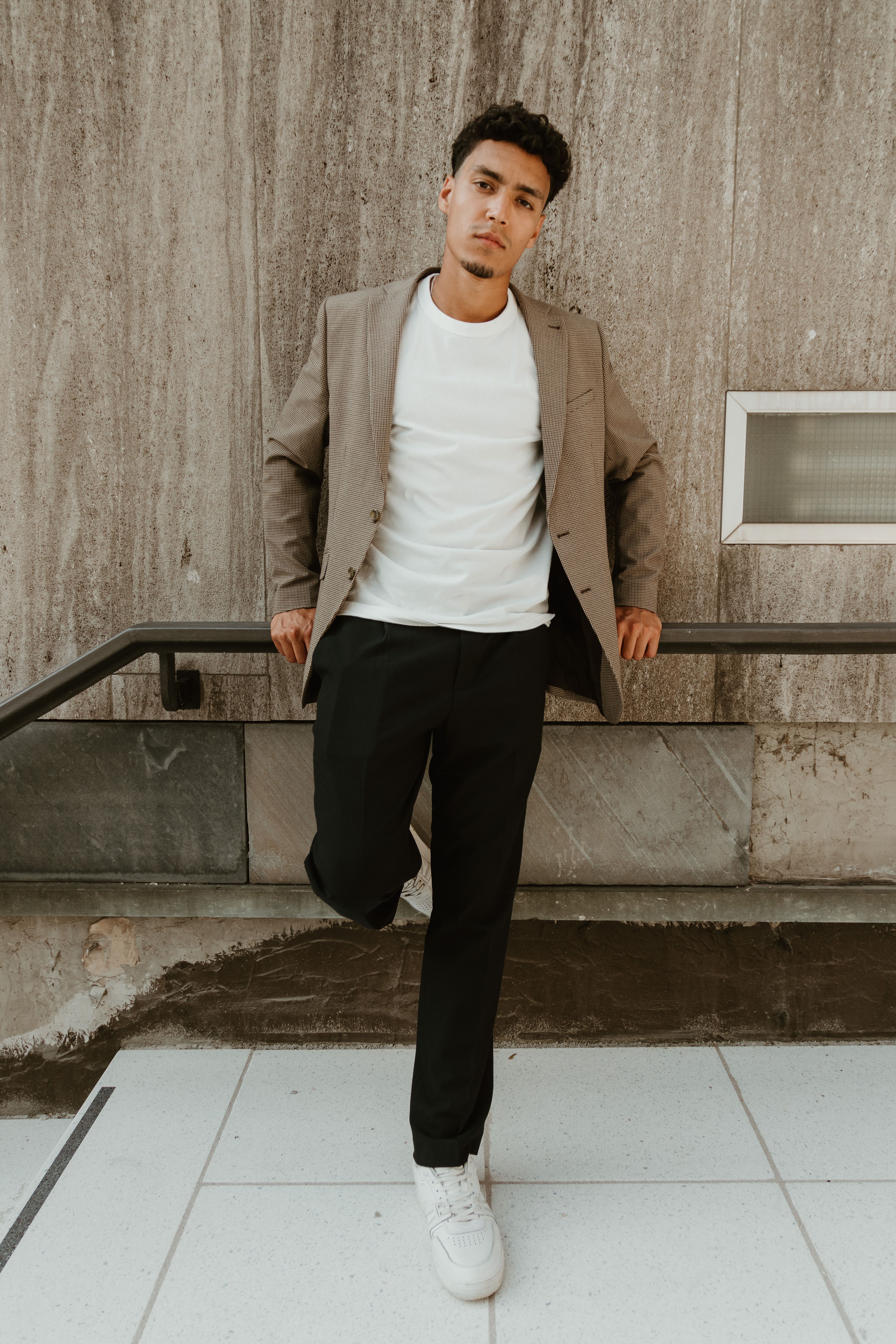 Urban Portrait of a Man Leaning Against Wall · Free Stock Photo
