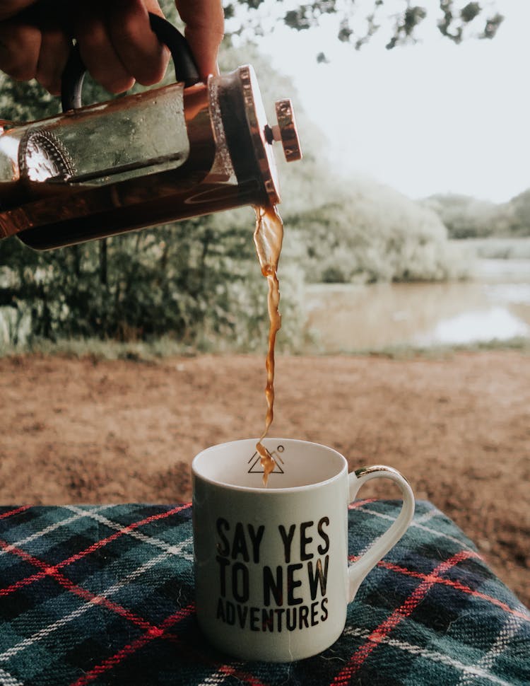 Photo Of Person Pouring Coffee In Mug