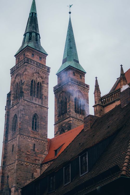 Free Capture of gothic church towers in Nuremberg's old town, highlighting historical architecture. Stock Photo