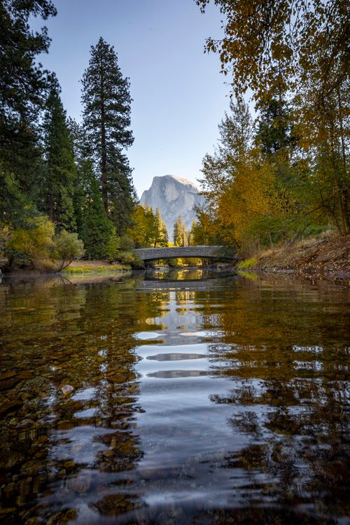 Free Beautiful autumn scene featuring Half Dome and a tranquil river in Yosemite National Park. Stock Photo