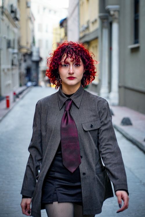 Confident Woman with Red Hair Walking in Urban Street · Free Stock Photo