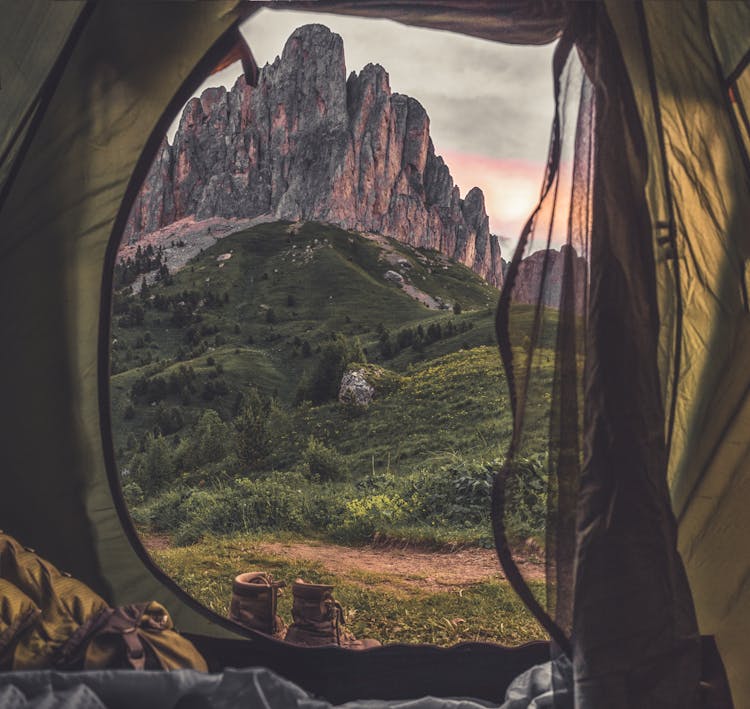 Person On Yellow And Gray Tent Looking At Mountain Scenery