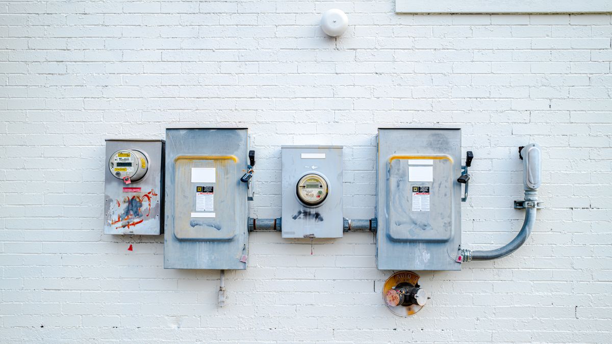 Electrical boxes and meters on a wall, where a transfer switch would connect a generator.