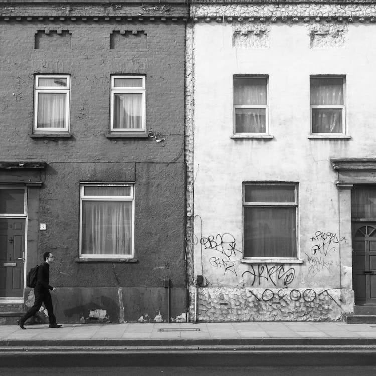 Man Walking On Sidewalk