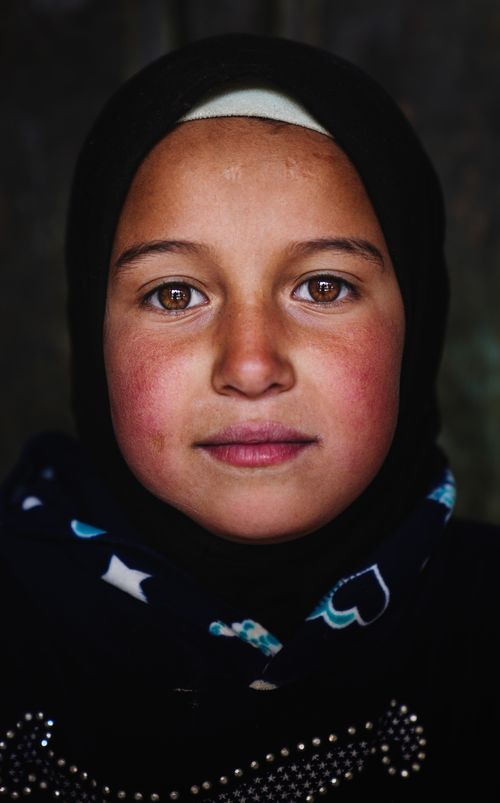 Free Close-up portrait of a young Middle Eastern girl wearing a headscarf in Ouarzazate, Morocco. Stock Photo