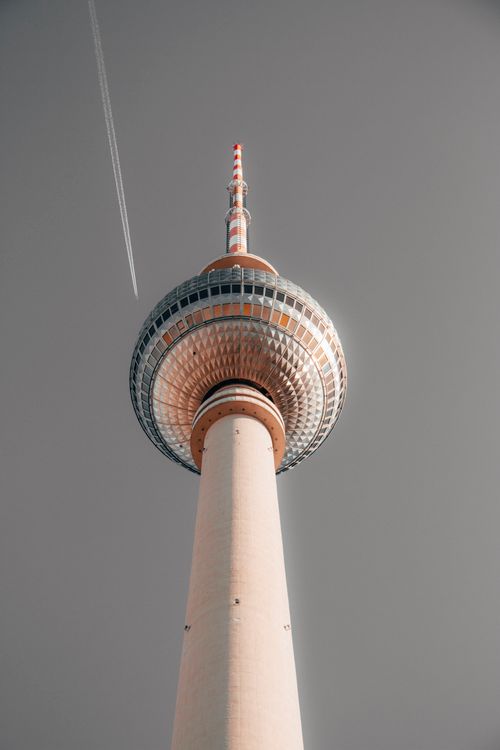 Free Striking low angle view of Berlin's iconic TV Tower against a dramatic sky, embodying urban architecture. Stock Photo
