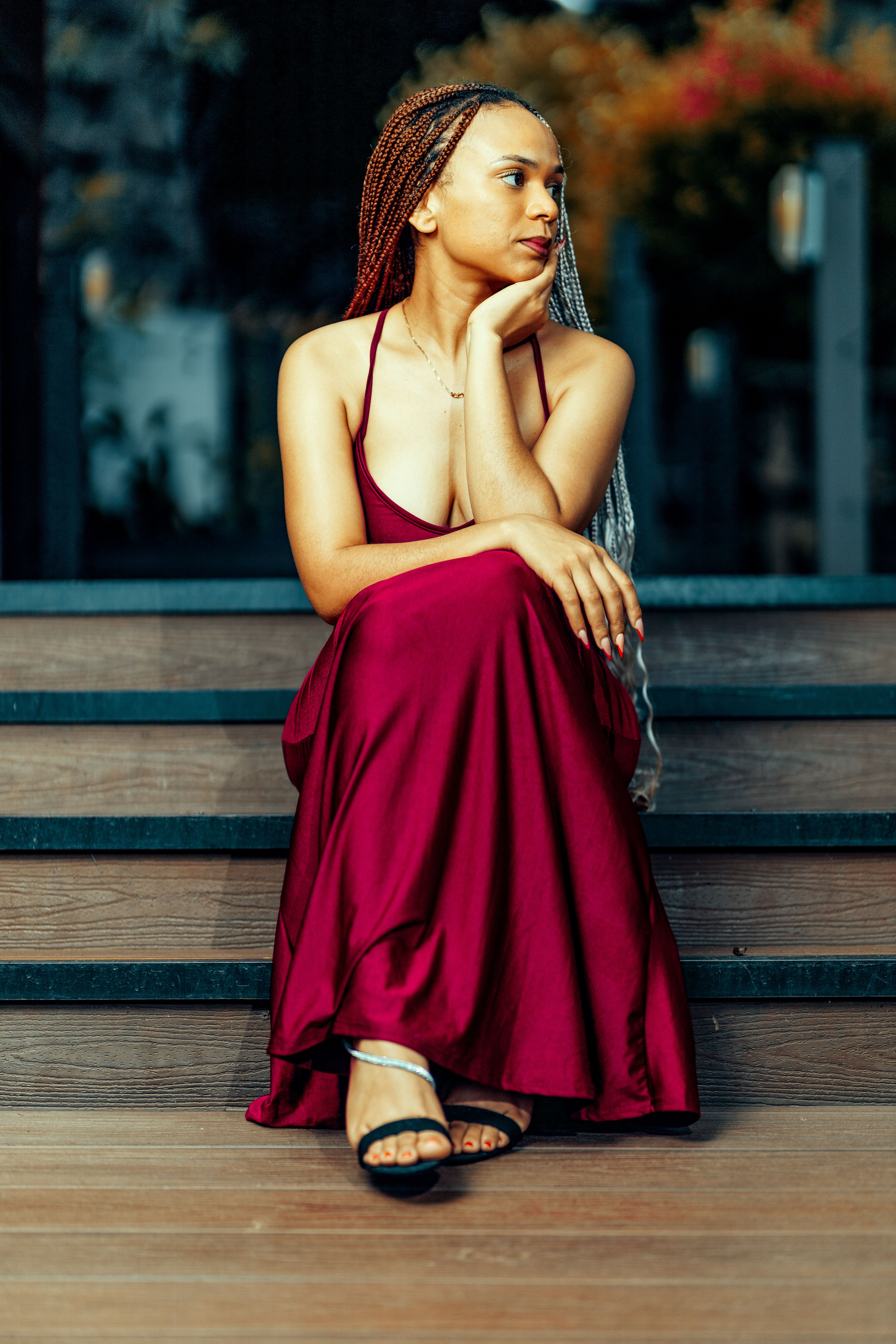 Elegant Woman in Red Dress Sitting on Steps · Free Stock Photo