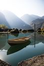 A peaceful fjord in Norway with a boat and mountains reflecting in the water.