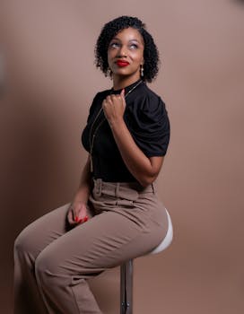 Stylish portrait of a woman in elegant attire, exuding confidence and charm.