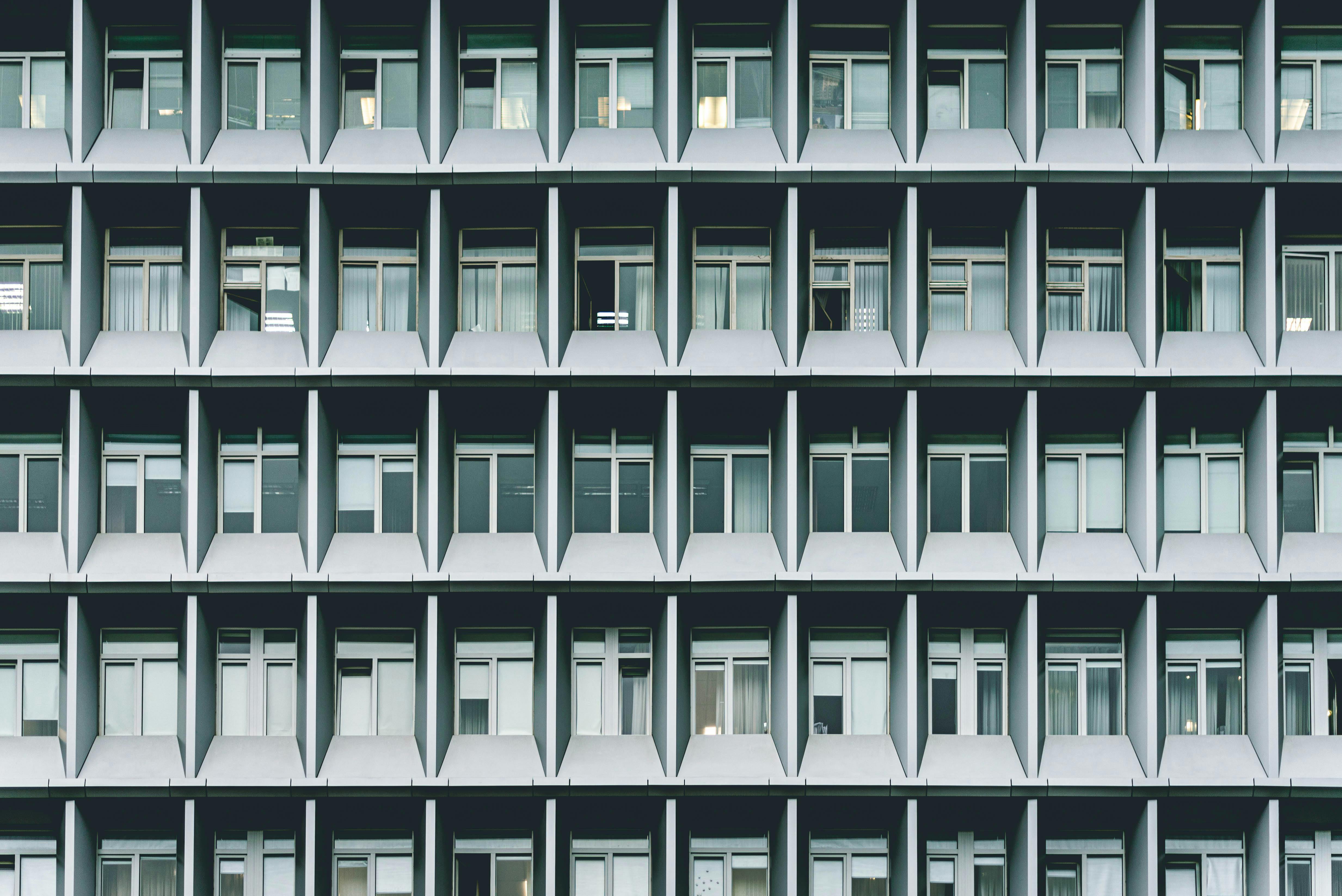 Grayscale Photography of Concrete Building Windows