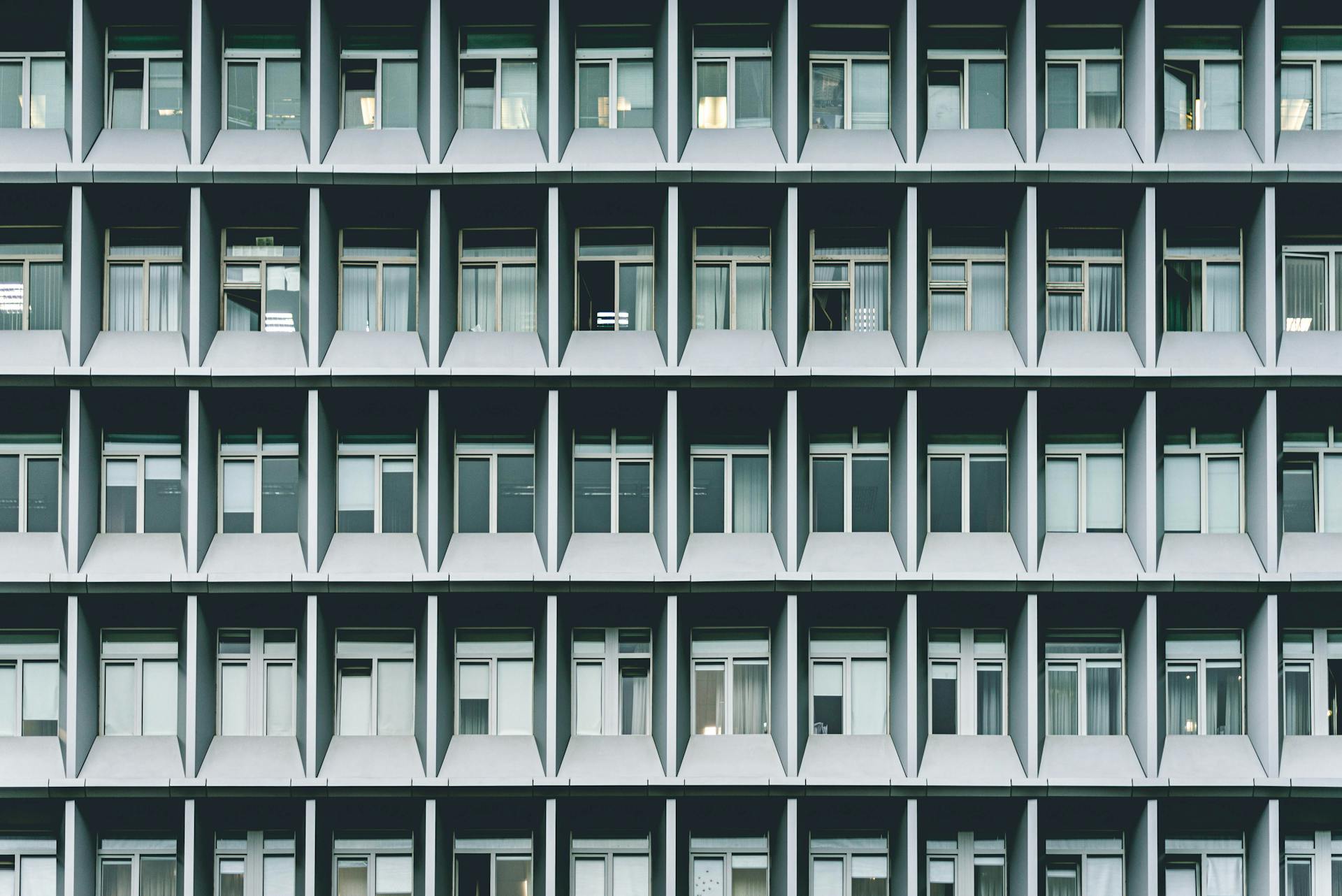 A detailed view of a symmetrical modern office building with a grid of windows.