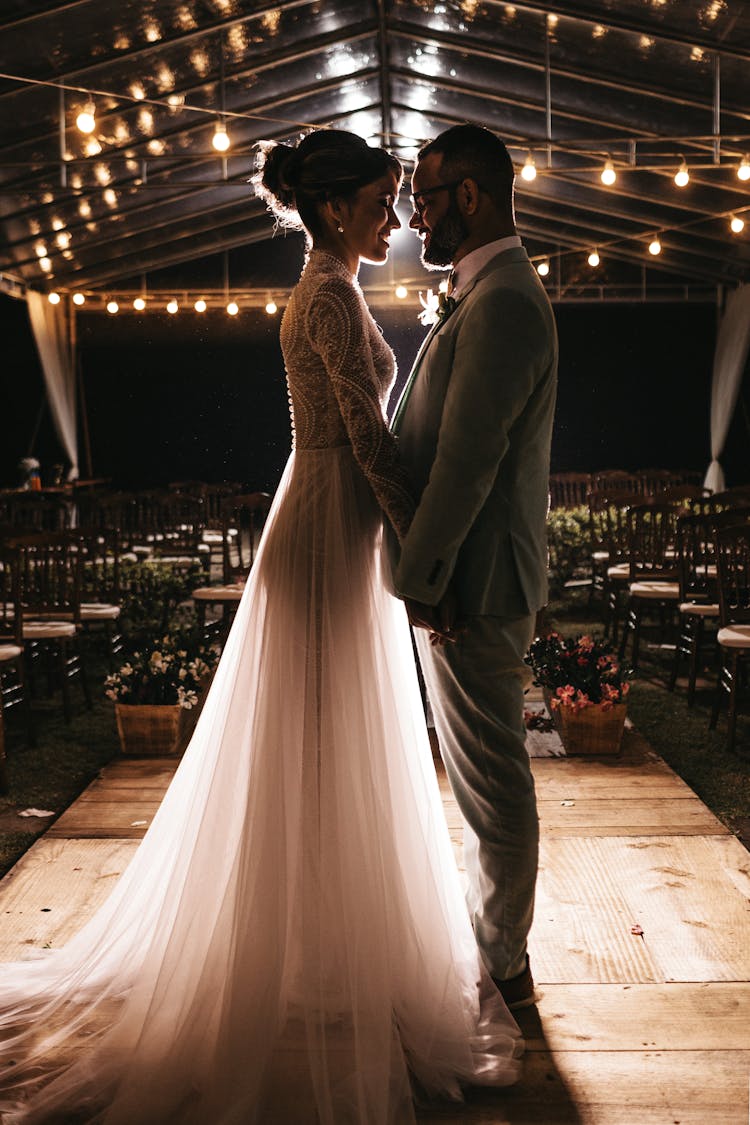 Man Standing In Front Of Woman In White Wedding Dress