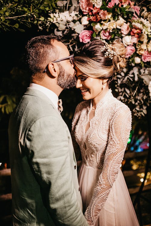 Man Kissing Woman Forehead