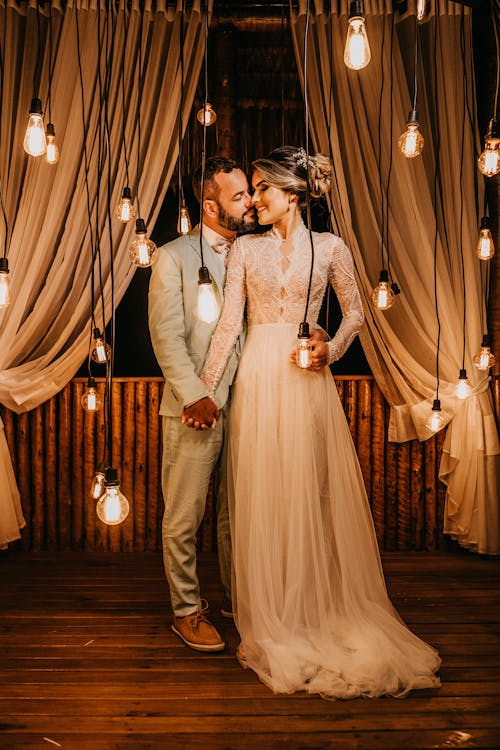 Couple Standing Near Pendant Lights