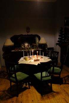 A dimly lit dining table with candles creating a warm, inviting atmosphere.