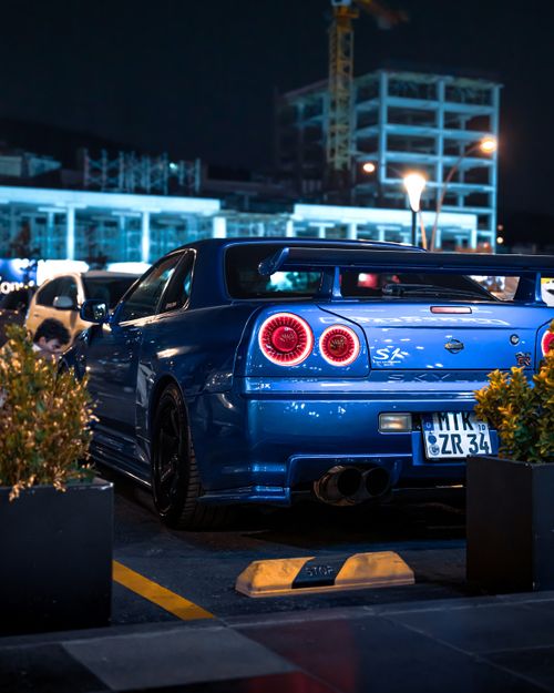 Free Blue sports car showcased in a vibrant night scene in Ankara, Türkiye. Stock Photo