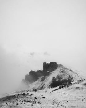 Black and white photo of a misty, snow-covered rock formation in Wenatchee, Washington's winter landscape.