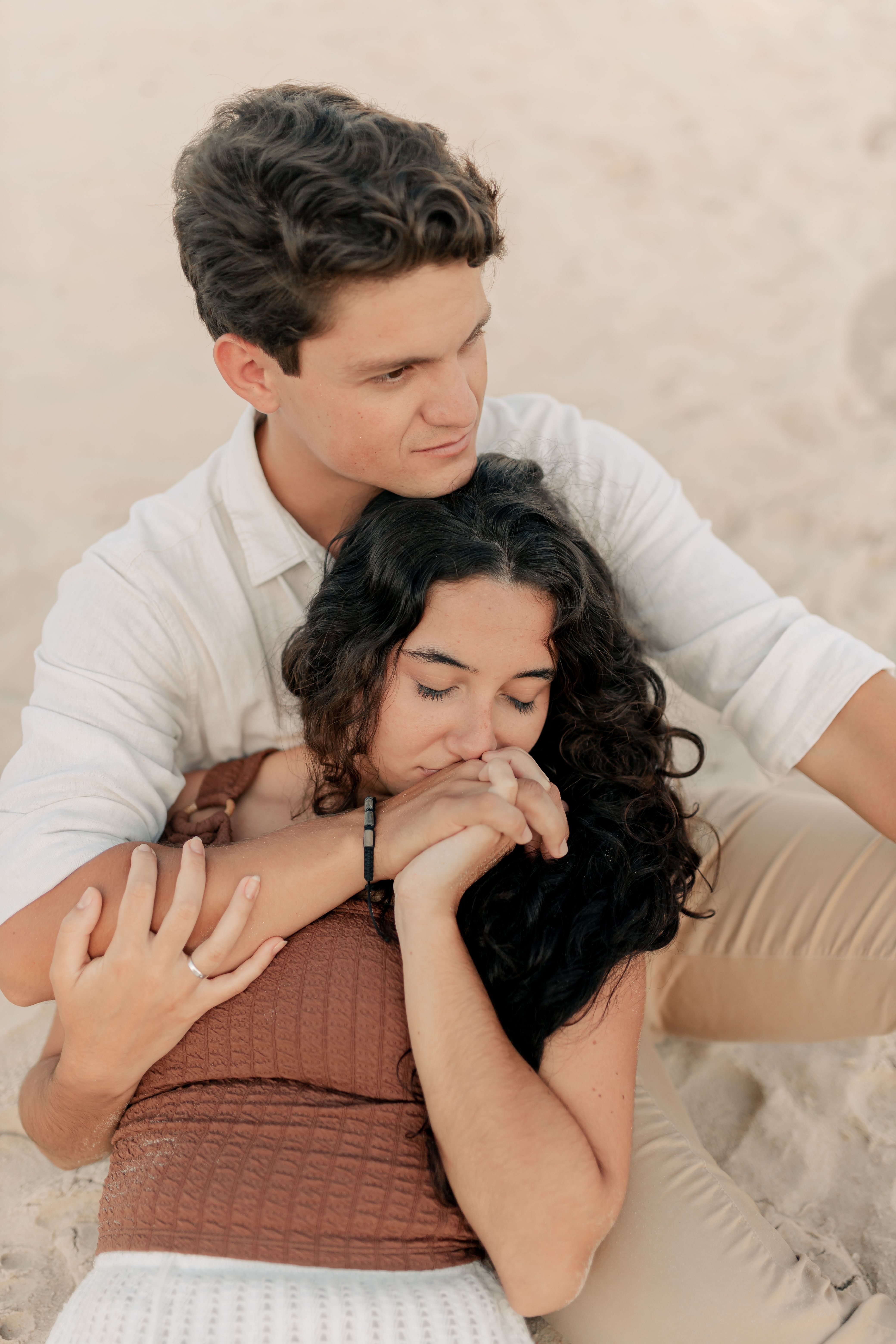 Romantic Beach Couple Embracing at Sunset · Free Stock Photo