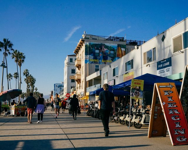 Venice Beach boardwalk Busy Venice Beach boardwalk lined with palm trees on a sunny day