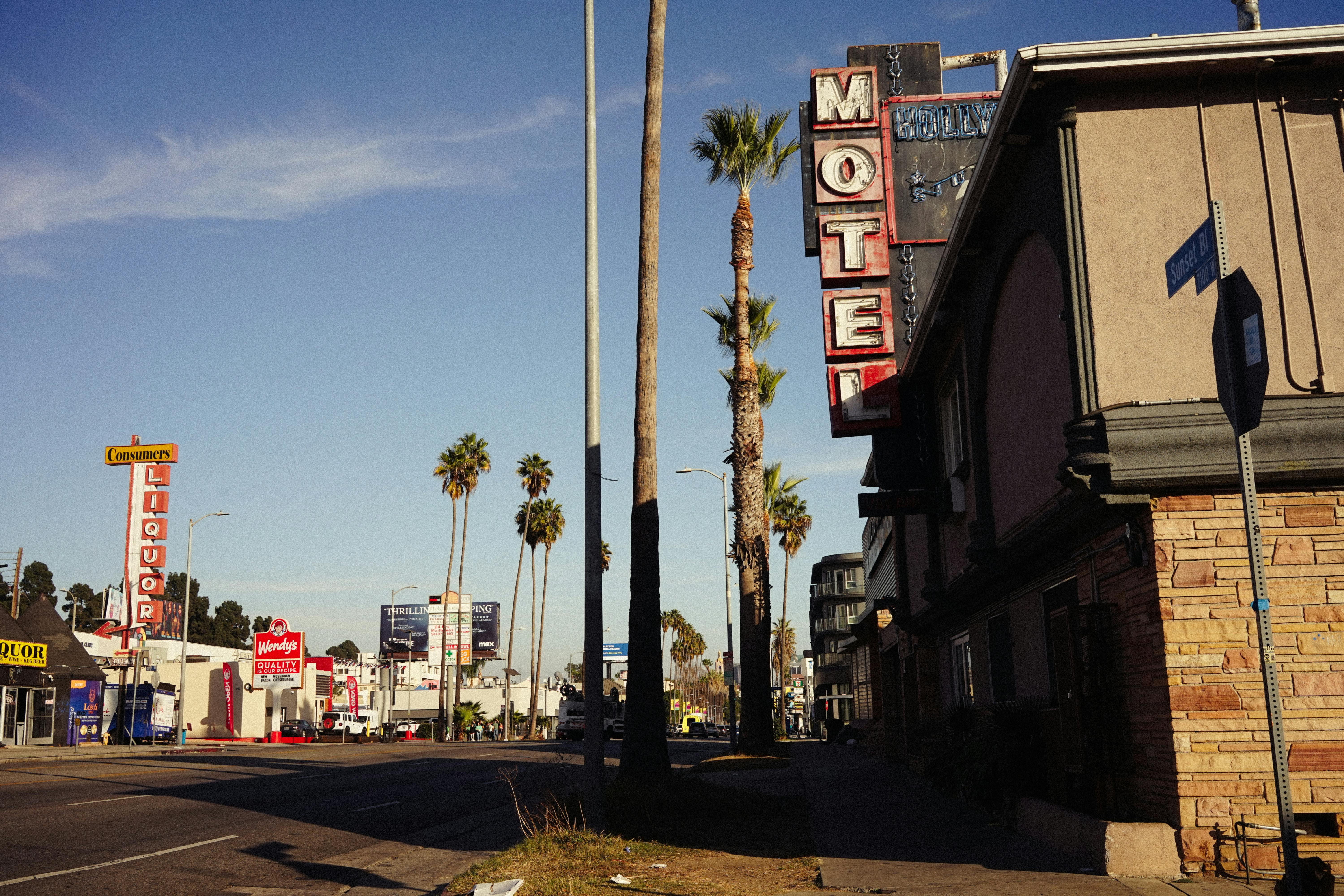 Free Vintage Hollywood street view with palm trees and retro motel sign. Stock Photo