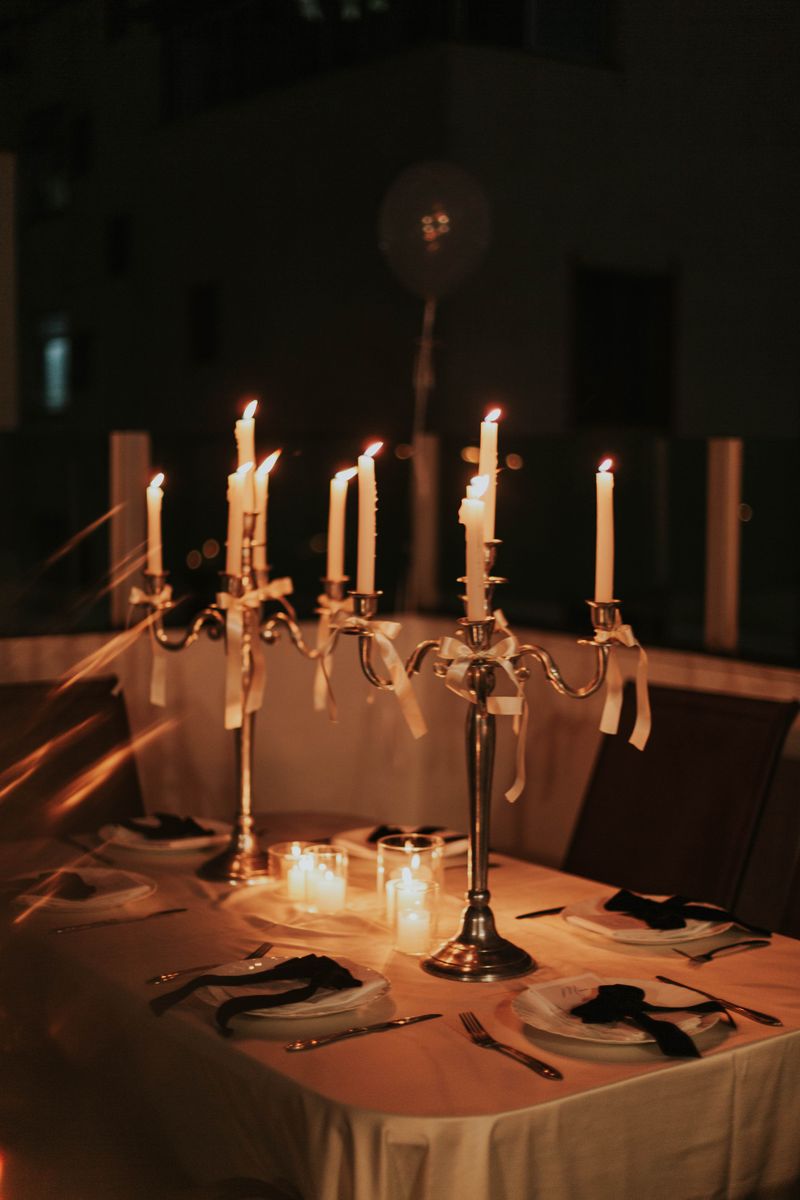 Elegant candlelit dinner table set for an evening party