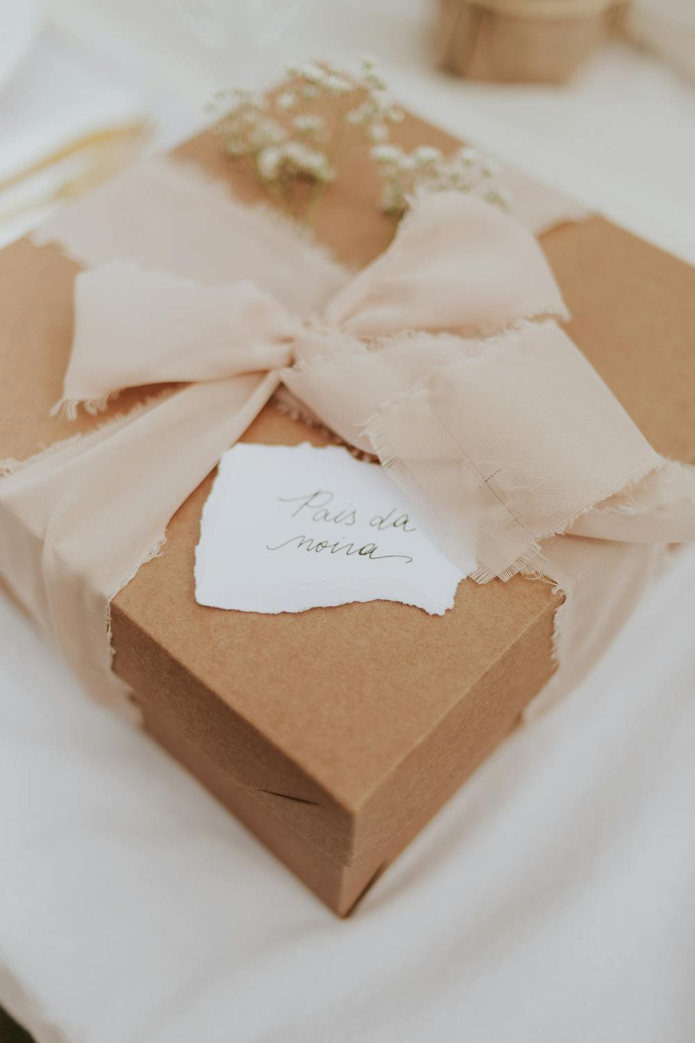 Elegant Wedding Gift Wrapped in Soft Ribbon · Free Stock Photo