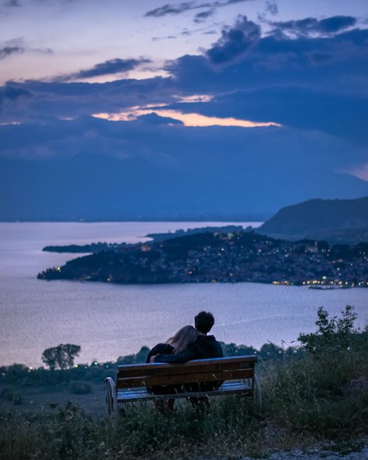 Couple enjoying a romantic sunset view over Lake Ohrid, a perfect summer evening in Macedonia.