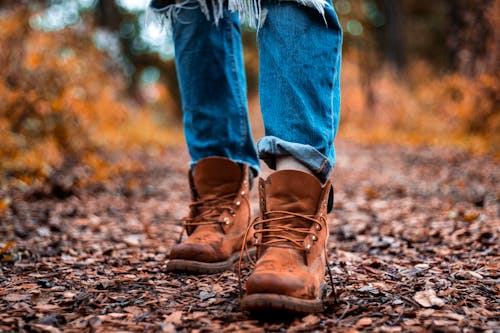 Free Shallow Focus Photography Of Blue Jeans And Brown Boots Stock Photo