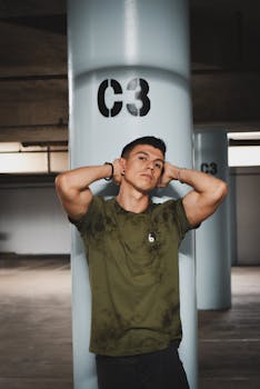 Young man posing confidently against a C3 pillar in an urban parking garage setting.