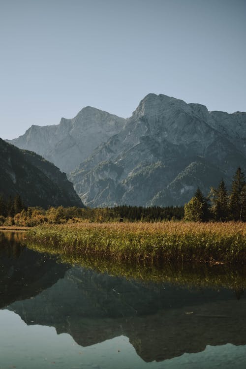 Free Body of Water and Gray Mountains Stock Photo