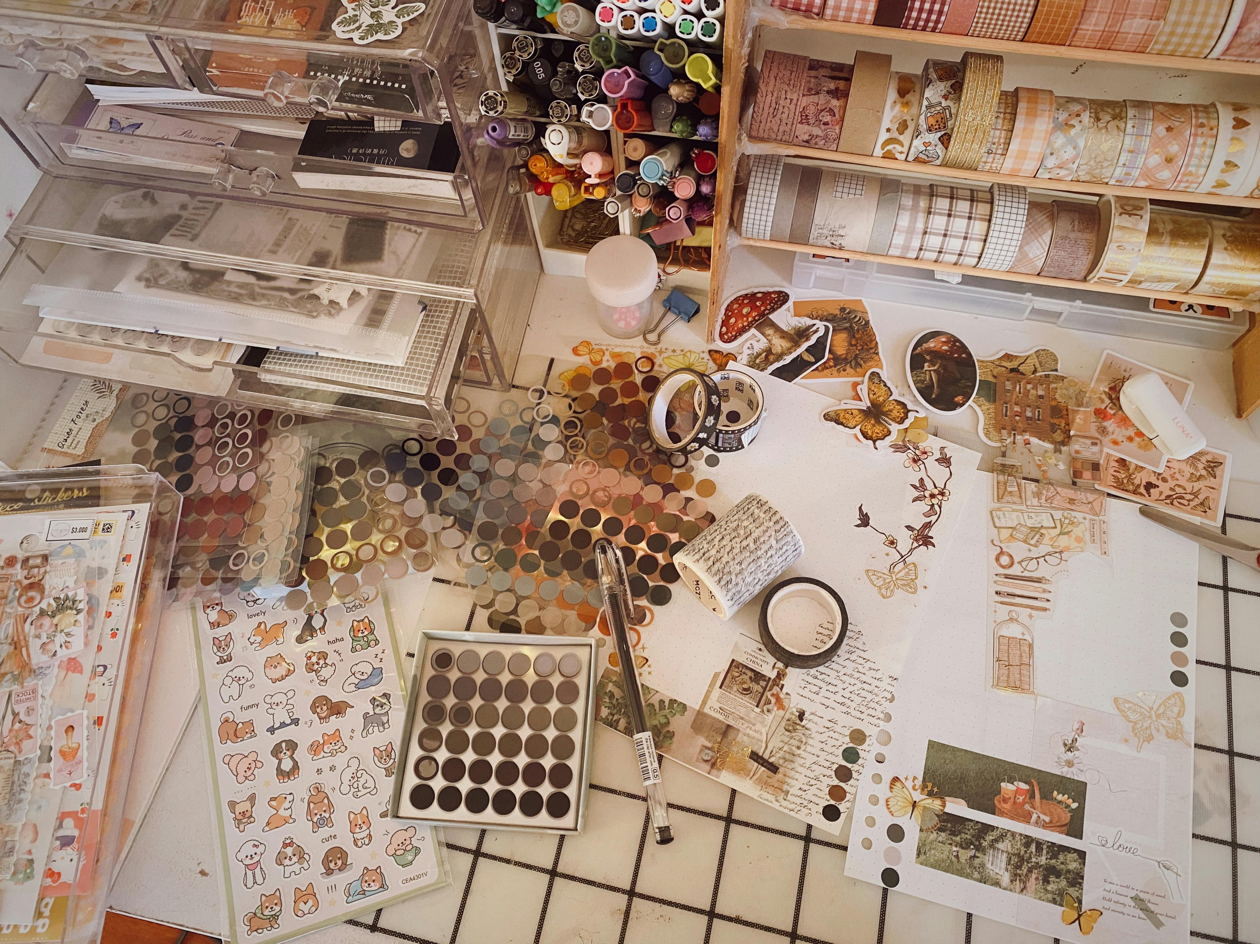 A vibrant collection of scrapbooking supplies including stickers, washi tape, and pens.
