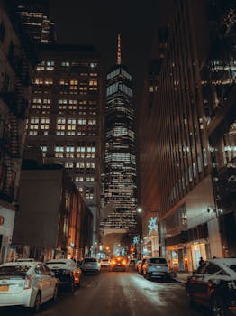 Captivating night view of a New York City street focusing on a towering skyscraper.