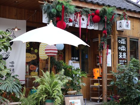 Charming Asian restaurant with winter decorations and vibrant plants.