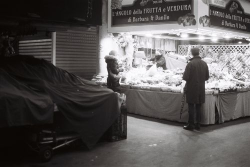 Free Monochrome street scene of people at a market at night. Stock Photo