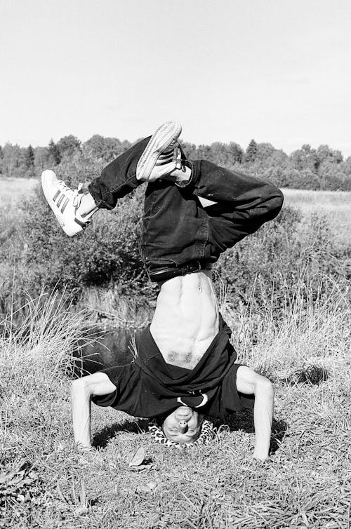 Grayscale Photography Of Man Doing A Handstand