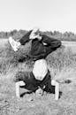 Grayscale Photography Of Man Doing A Handstand