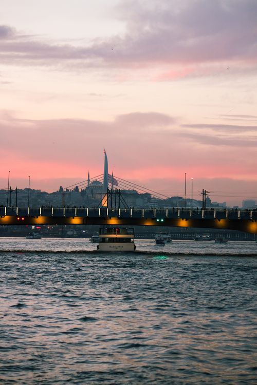 Free Serene sunset over Golden Horn with a striking view of Istanbul's bridge and skyline. Stock Photo