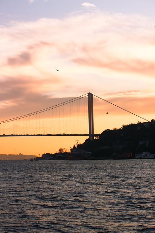 Free Silhouette of Bosphorus Bridge against a vibrant sunset sky in Istanbul. Stock Photo
