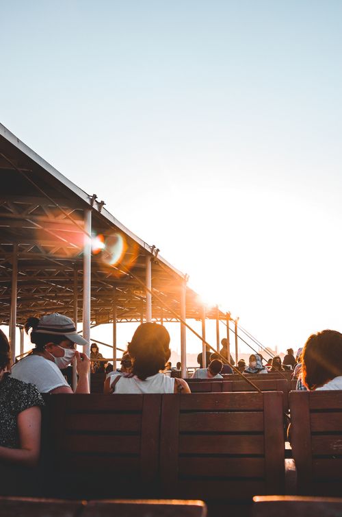 Free Silhouetted group of people enjoying sunset on a rooftop terrace, highlighting a relaxed atmosphere. Stock Photo