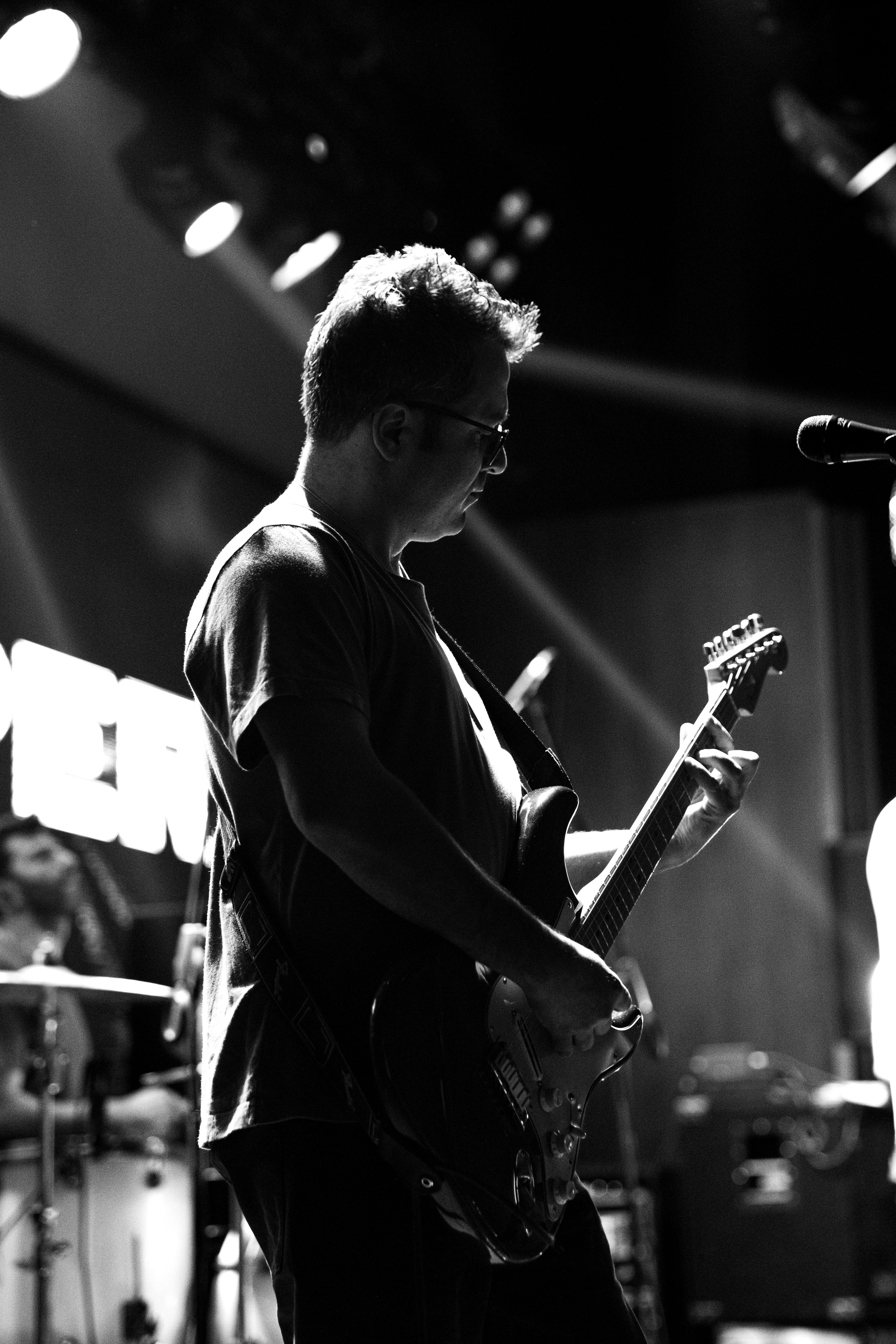 Black and white photo of a guitarist performing live on stage in Eskişehir, Türkiye.
