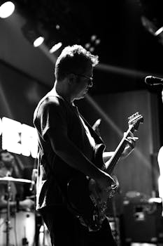 Black and white photo of a guitarist performing live on stage in Eskişehir, Türkiye.