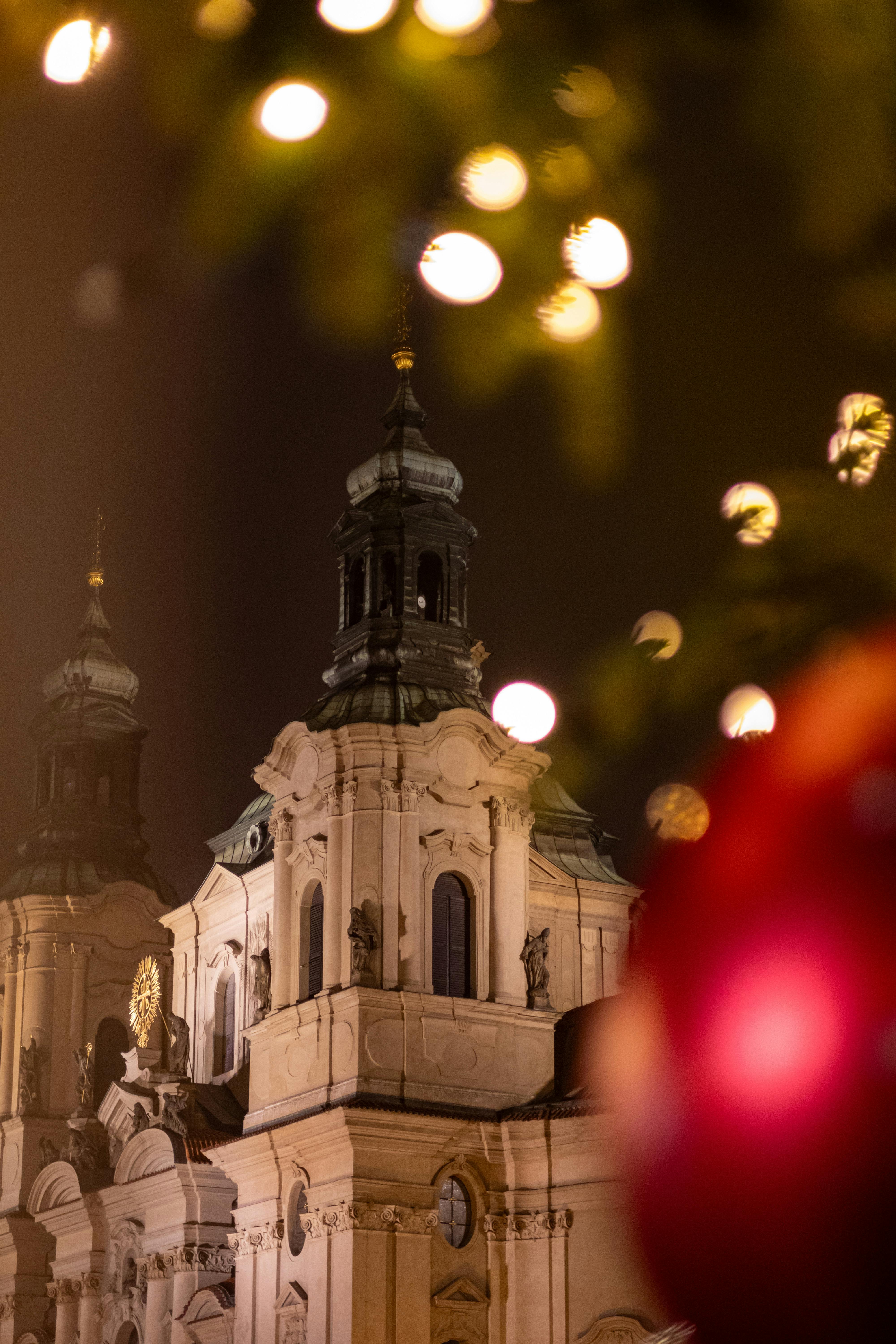 St. Nicholas Cathedral illuminated at night with festive holiday decorations in foreground.
