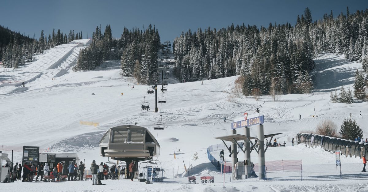 A bustling ski resort in Colorado with snow-covered slopes and people enjoying winter sports.
