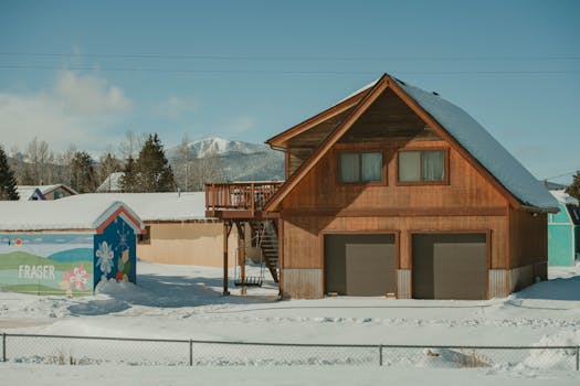A cozy wooden cabin surrounded by snow in scenic Fraser, Colorado.