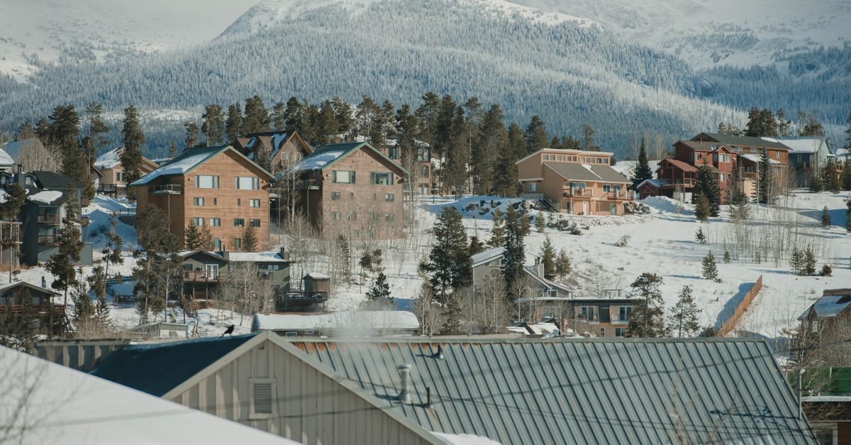 Scenic winter view of Breckenridge, Colorado with snow-covered houses and mountains.